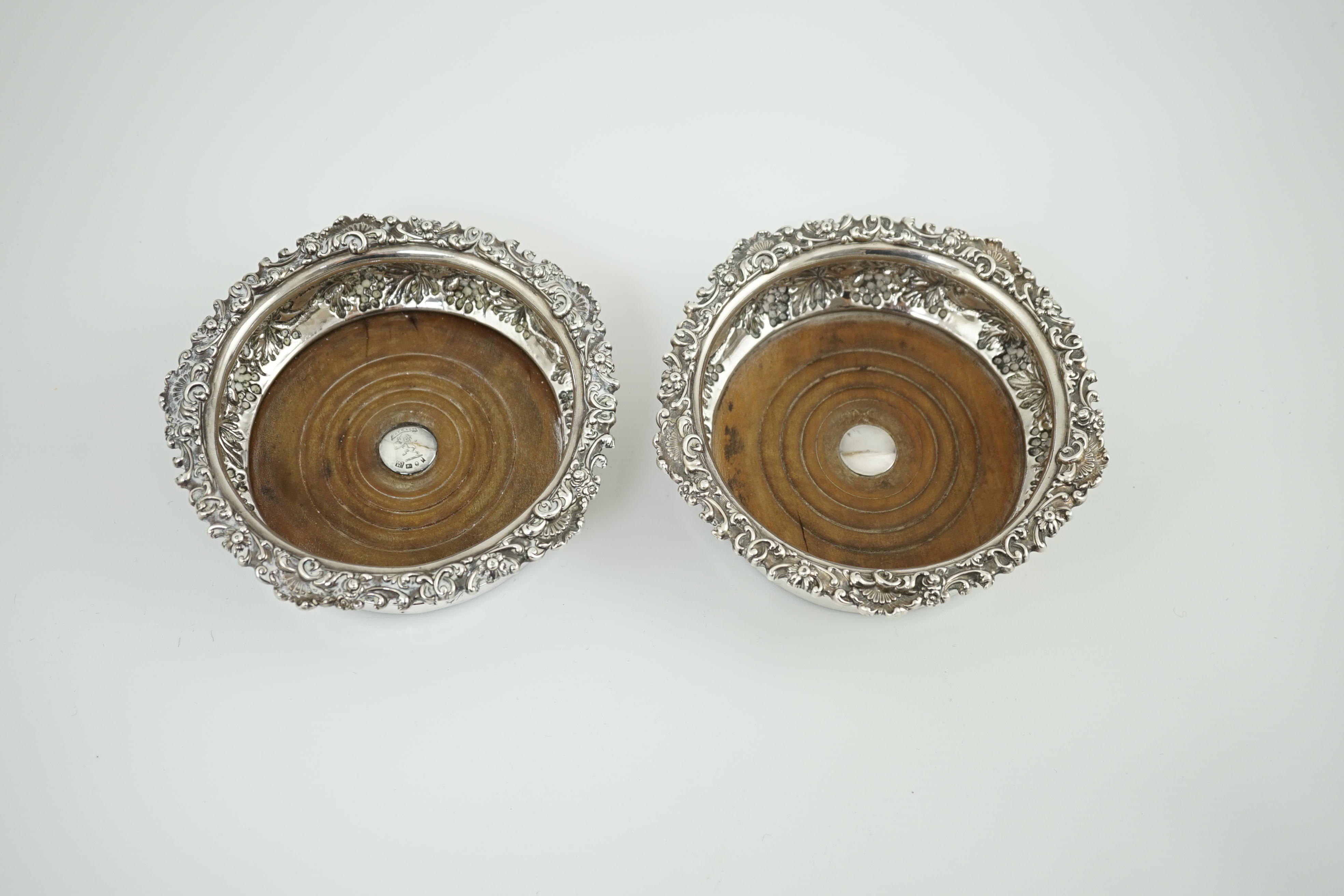 A pair of George IV silver wine coasters, by S.C. Younge & Co